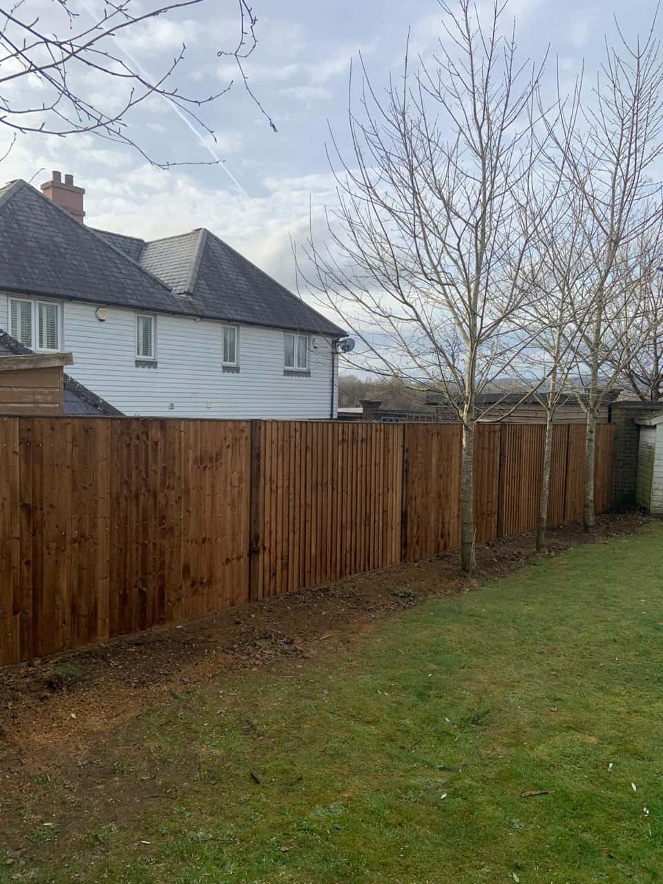 This is a photo of feather edge fencing installed in a residential properties garden by Fast Fix Fencing Mildenhall