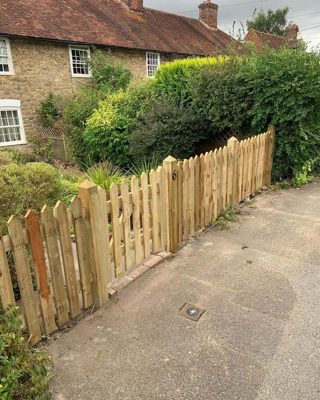 This is a photo of a picket fence and picket gate installed by Fast Fix Fencing Mildenhall