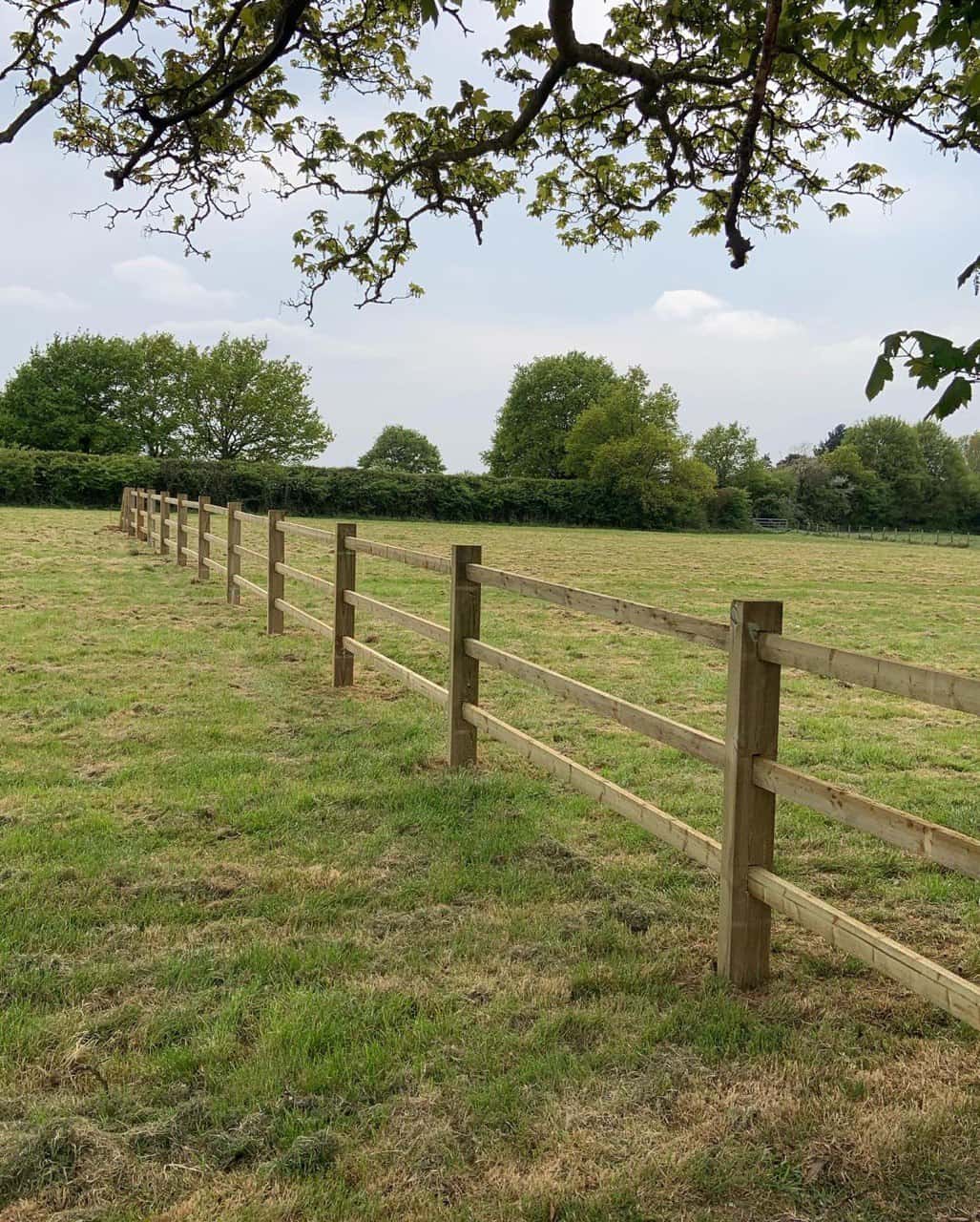 This is a photo of a post and rail fence installed in a field by Fast Fix Fencing Mildenhall